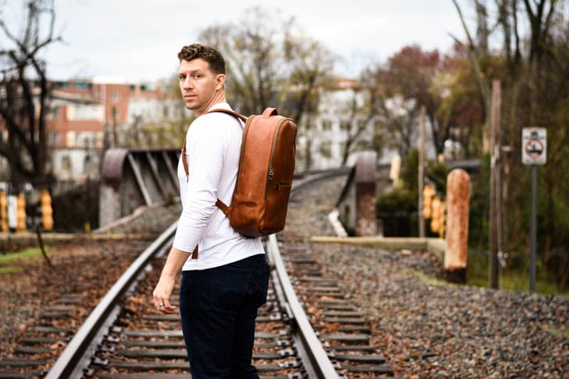 Model Looking back at camera with full grain leather backpack