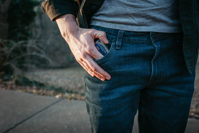 model putting wallet into The Perfect Jean denim