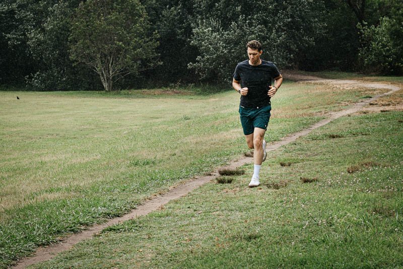 model running in the distance with vuori workout shorts