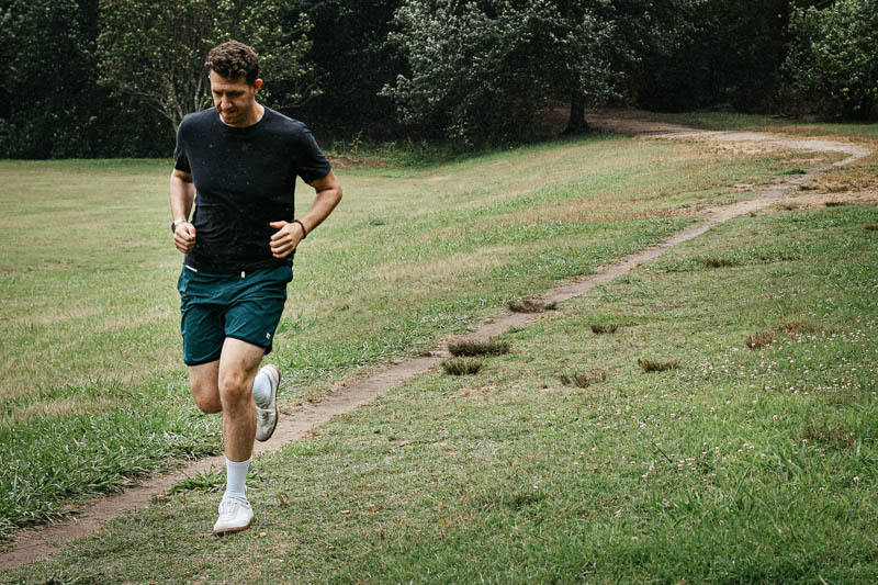 model running wearing vuori workout shorts and tradewind t shirt