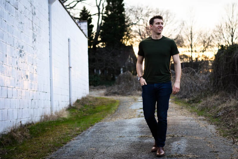 model smiling wearing boots and green tshirt