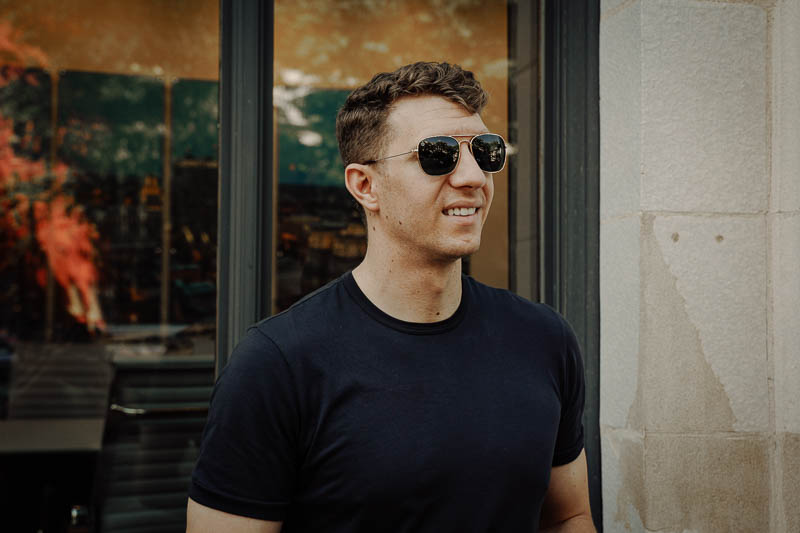 Knockaround Sunglasses Review: Shades for the River 13 model smiling wearing knockaround sunglasses