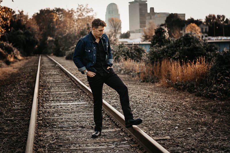 Mott and bow jay model standing on train tracks wearing MKE boot company