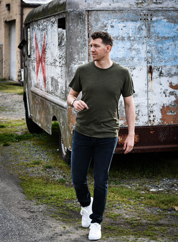 model walking toward camera with green rag and bone tshirt and white sneakers