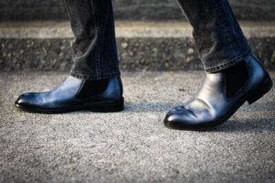 model walking with blue chelsea boots