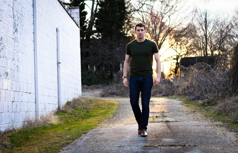 model walking with threshold tshirt jeans and chelsea boots sunset
