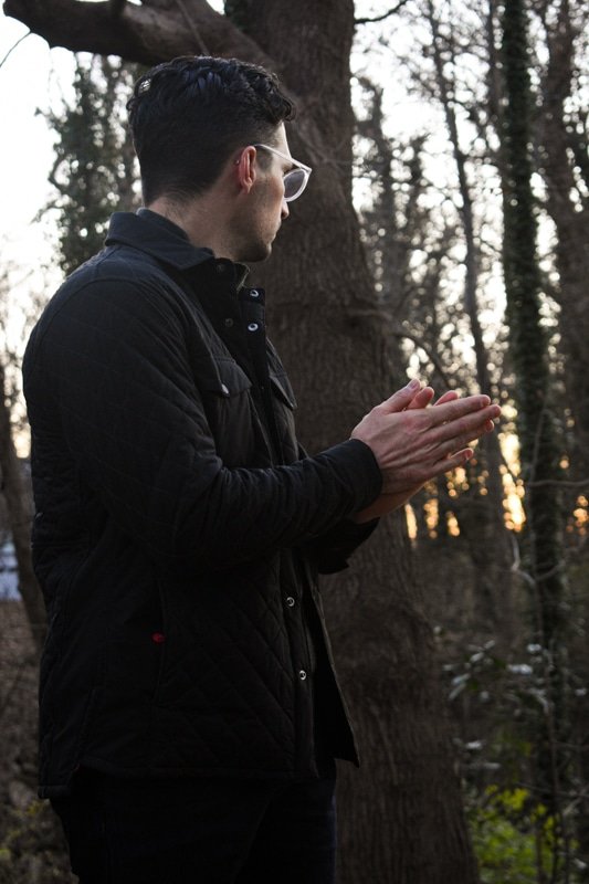 model warming hands wearing quilted jacket