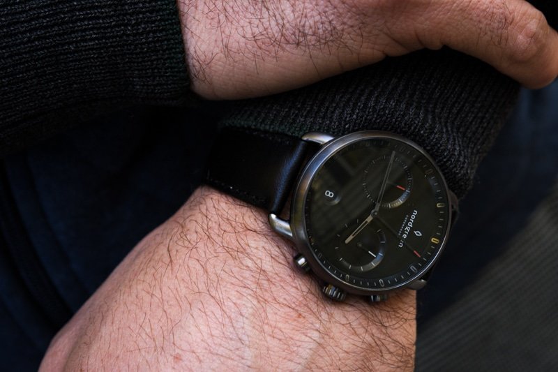 model wearing black dial pioneer