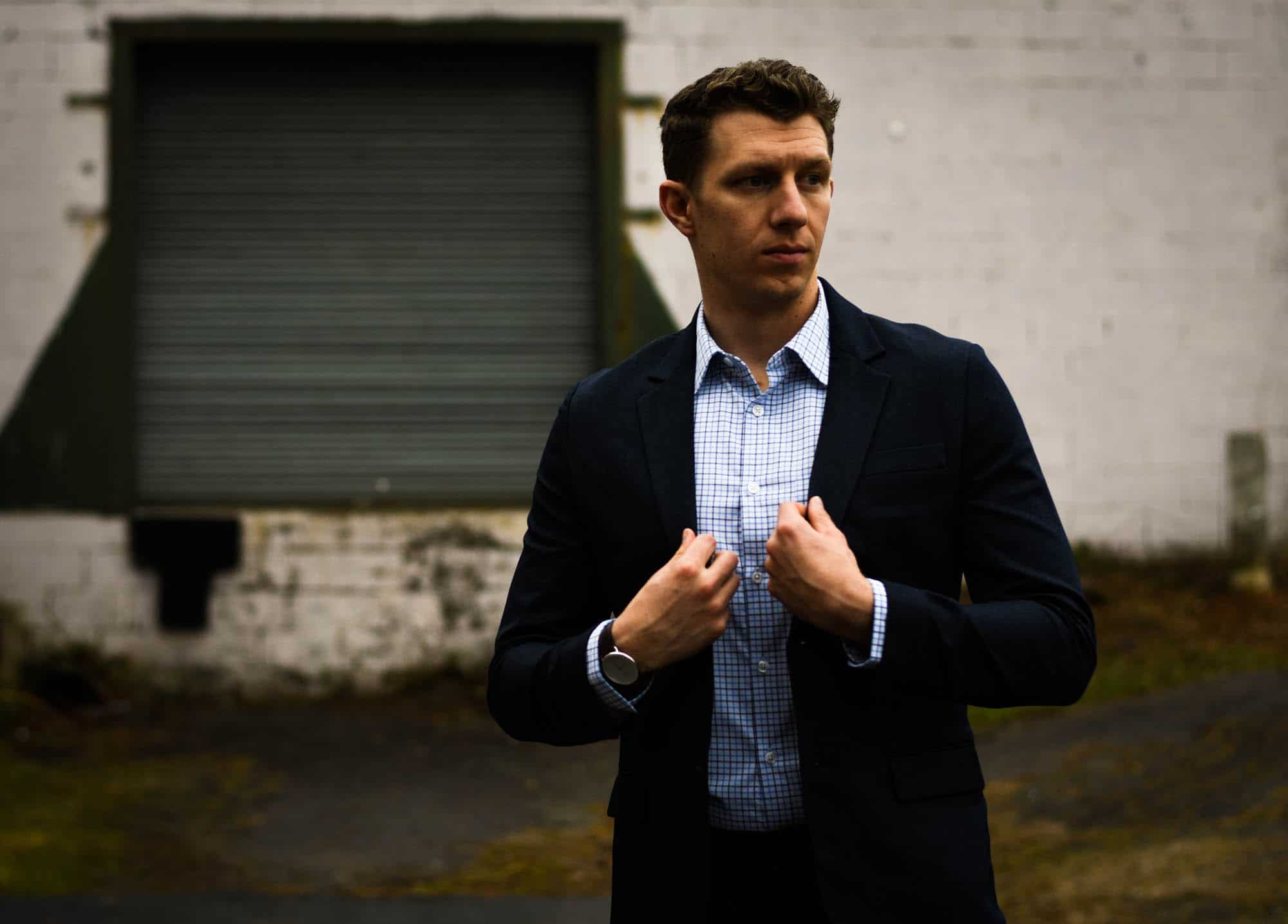 model wearing blue checked meridian shirt and navy gramercy travel suit