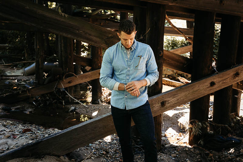 model wearing GAP denim shirt checking watch