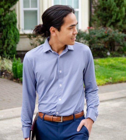 Model Wearing Mizzen+Main Beckett Dress Shirt with Hand in Pockets and Holding a Folder