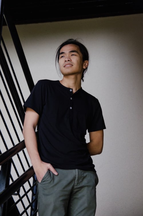 Model Wearing Mizzen+Main Tohono Henley Standing in Staircase