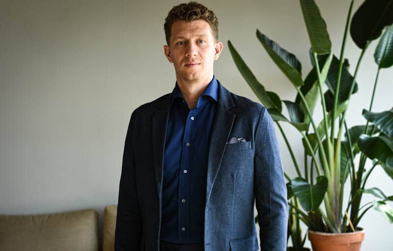 model wearing navy suit and dark blue shirt