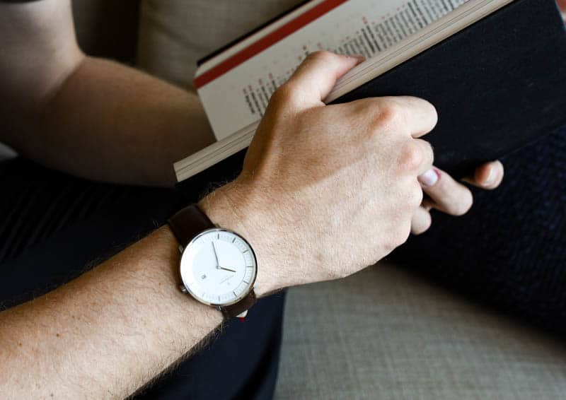 model wearing nordgreen philosopher while reading book