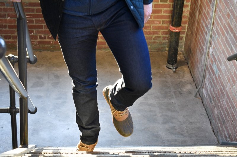 model walking up steps in mott and bow jeans and boots