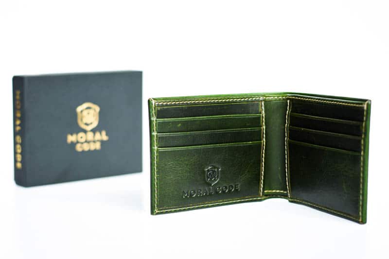 opened moral code green leather wallet on white background with product box