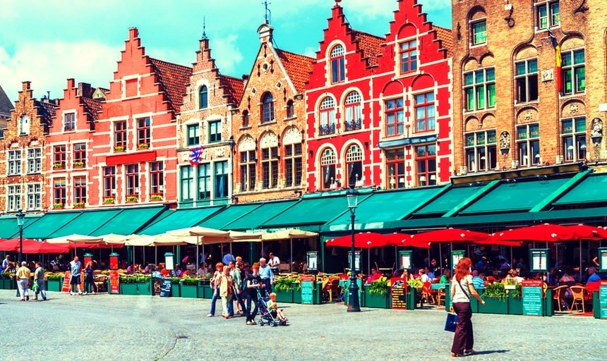 People in Vintage Homes on Market Square, Bruges