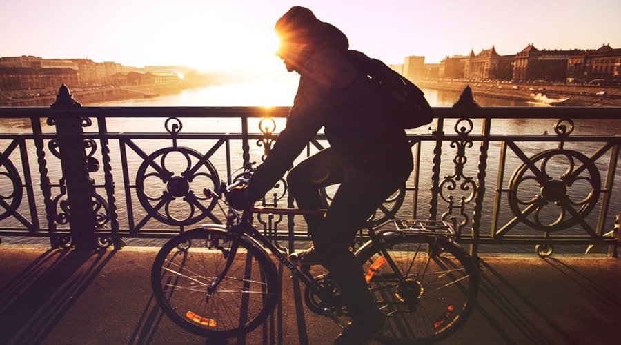 Man on bike riding along boardwalk