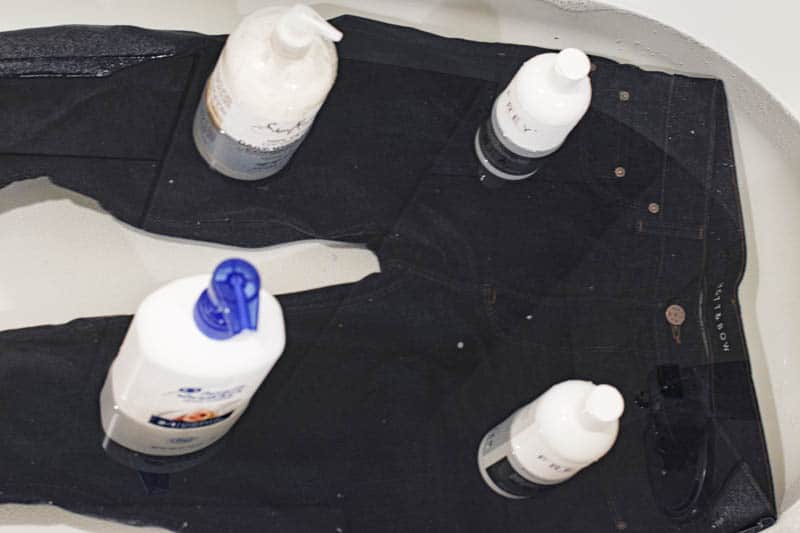 place heavy bottles on jeans to submerge