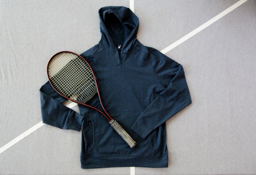 Product Shot of Public Rec Politan Hoodie With A Tennis Racquet