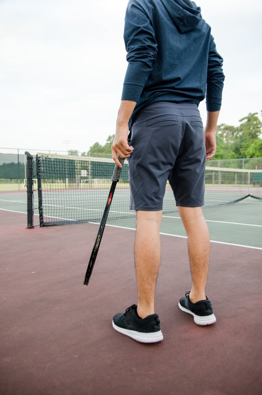 Reverse Shot Of Model Wearing Public Rec All Day Every Day Short Holding Tennis Racquet