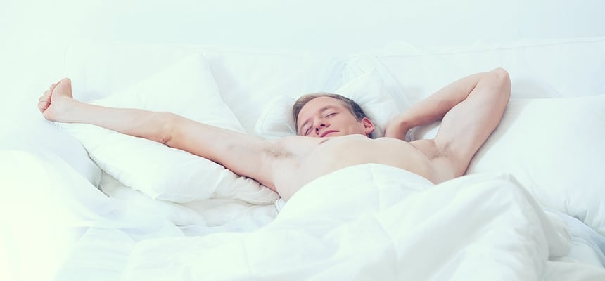 Single man waking up in bed with sheets