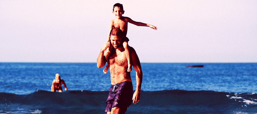 Man at beach with family