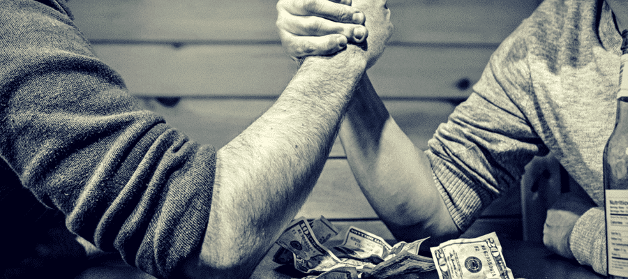 Men arm wrestling for money