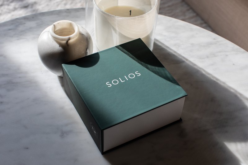 Solios packaging on marble table from the side