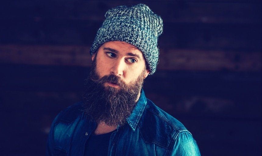 Stylish man with beard and beanie and denim jacket