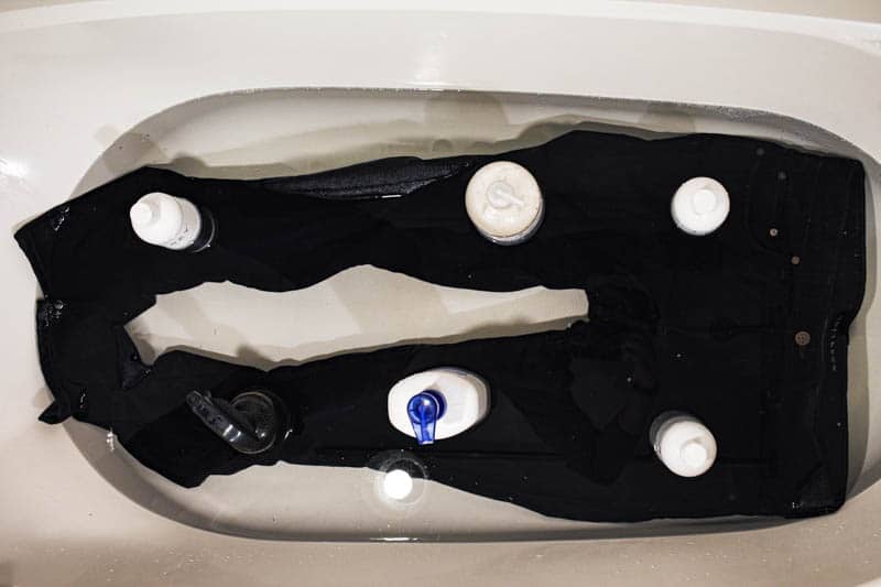 top down bottles on jeans submerged under water soaking