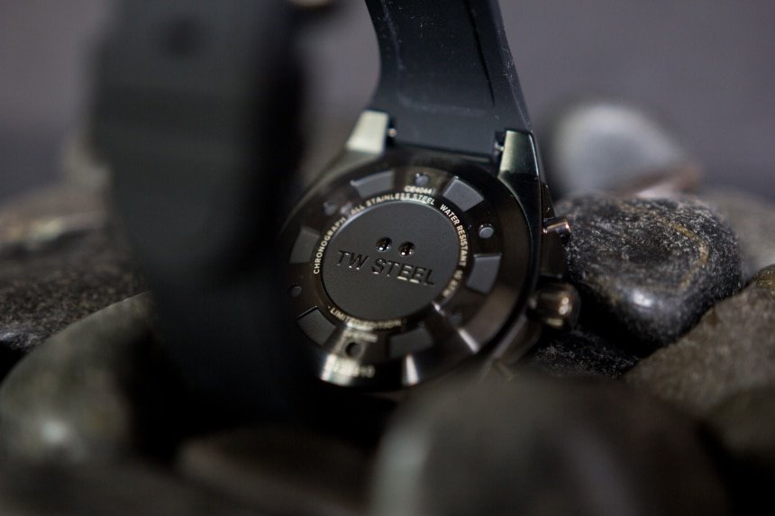 TW Steel Watch Review: Down To Business With The CEO Tech 9 TW Steel CEO Tech watch back facing with logo propped on top of black stones on black background c