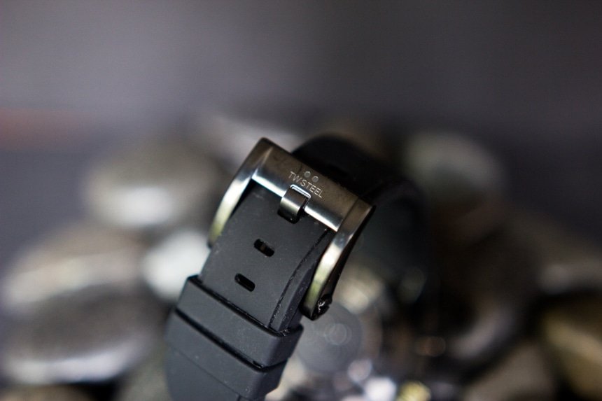TW Steel Watch Review: Down To Business With The CEO Tech 14 TW Steel CEO Tech watch band and clasp with logo back facing propped on top of black stones on black background a