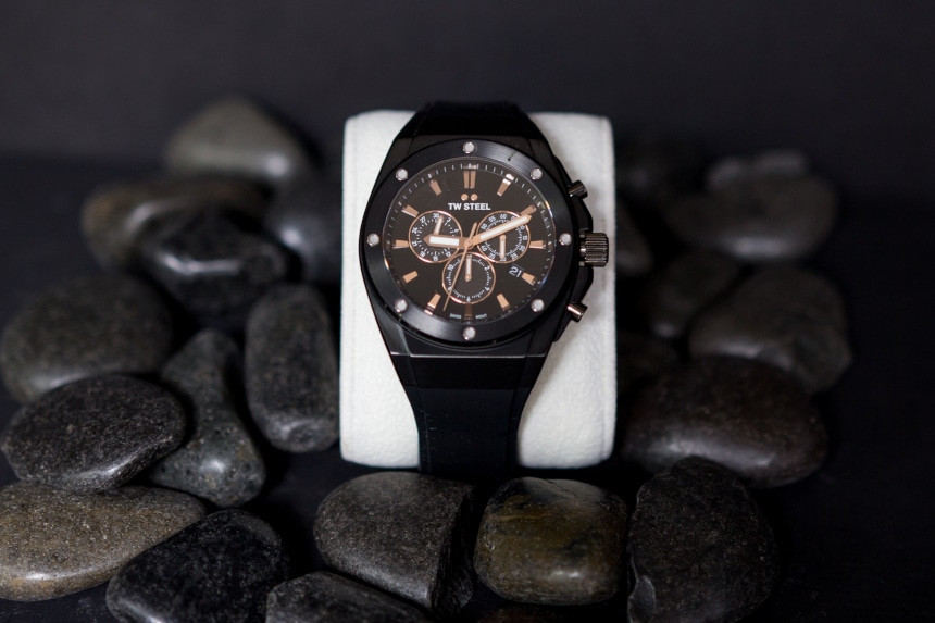 TW Steel CEO Tech watch propped up against black stones on black background a