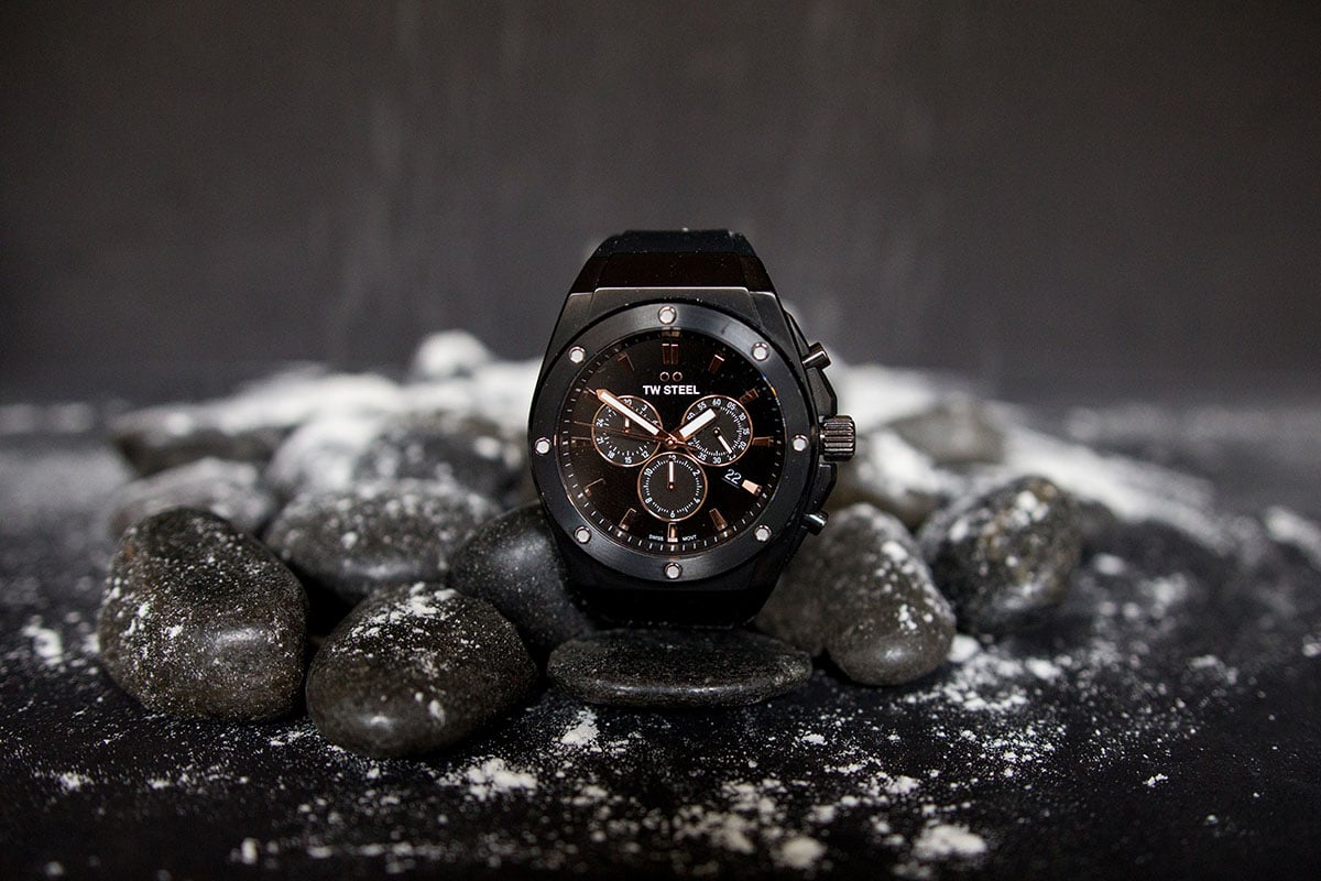 TW Steel CEO Tech watch propped up against black stones with snow on black background a 1
