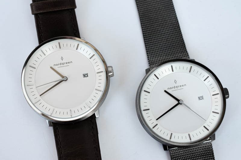 two philosopher watches side by side leather band and stainless steel band on white background
