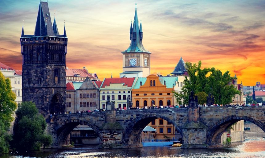 Tyn Church in Prague at sunset with bridge