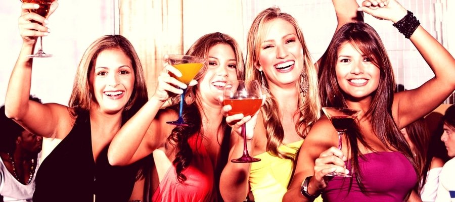 Group of girls having a night out with cocktails