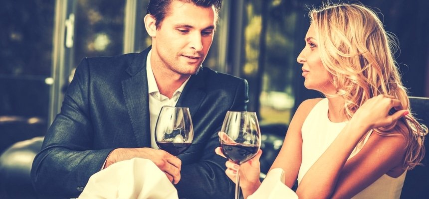 Attractive couple on a date in a restaurant with red wine
