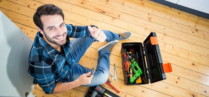 Man happy to be repairing kitchen sink