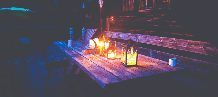 Outdoor candles and table at night