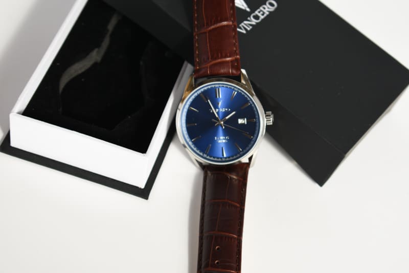 Vincero Kairos blue dial and brown strap lying on packaging