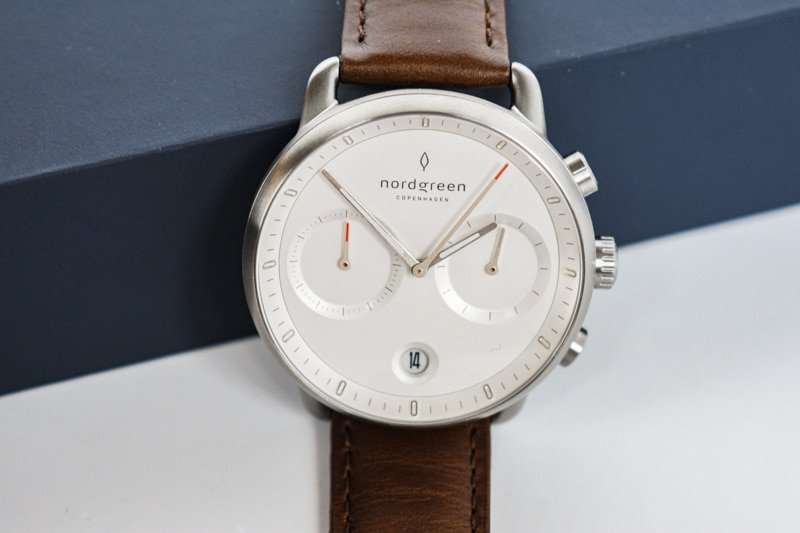 white dial nordgreen pioneer against blue packaging