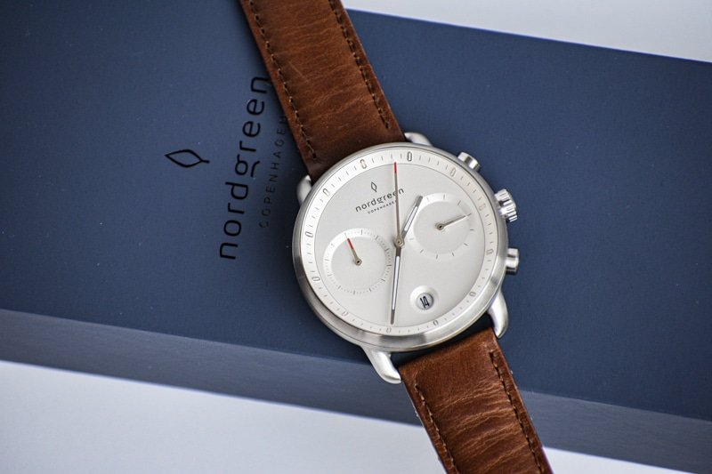 White dial pioneer against blue packaging